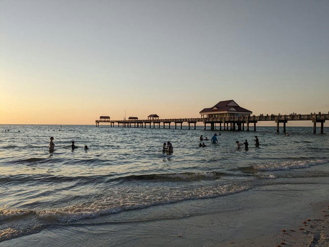 Pier 60 at Clearwater Beach at dusk with swimmers in the water