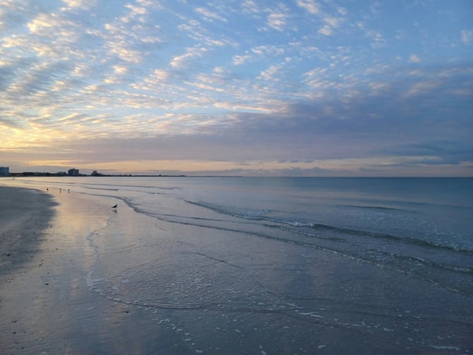 Calm beach shoreline at early morning with soft pastel sky
