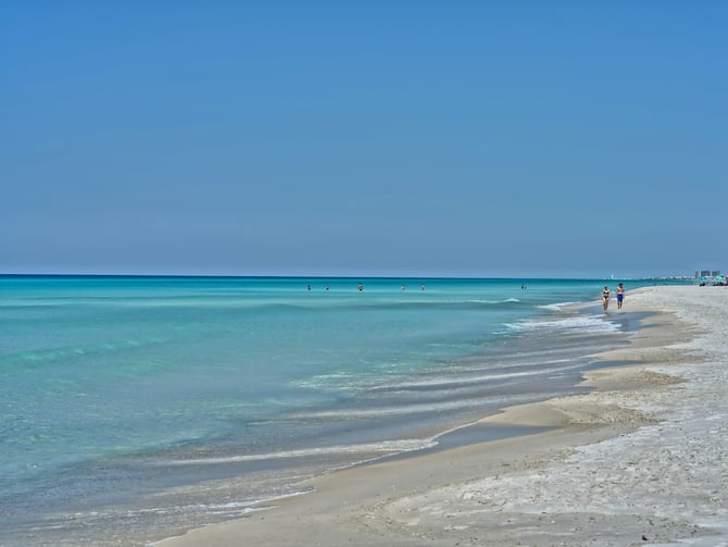 Clear turquoise water at Sand Key with a fisherman on the rocks